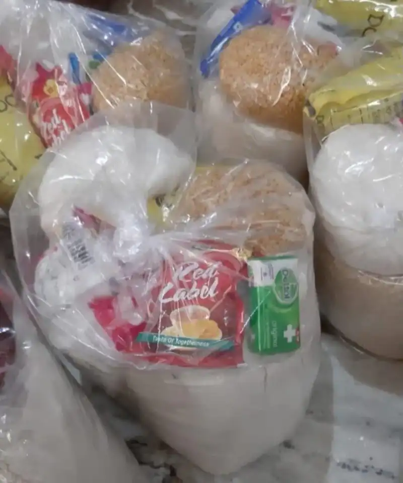 A household receiving a box of essential groceries